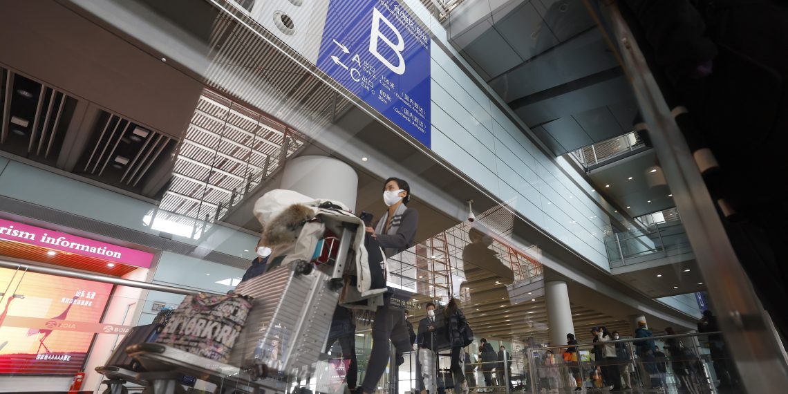 2023年1月8日，旅客推行李走出北京首都国际机场T3航站楼国际到达出口。