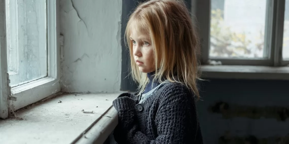 depressed-poor-girl-standing-near-window
